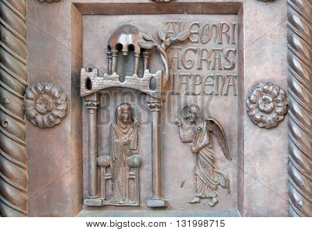 PISA, ITALY - JUNE 06, 2015: Annunciation of the Virgin Mary on the San Ranieri gate of the Cathedral St. Mary of the Assumption in Pisa, Italy on June 06, 2015