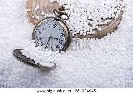 Retro Pocket Watch On White Polystyrene Balls