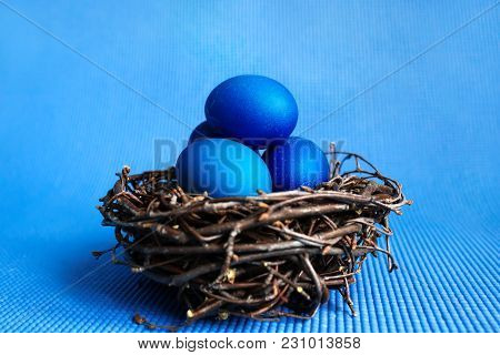 Easter Eggs In The Nest On Blue Background