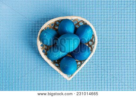 Easter Egg In The Basket On Blue Background