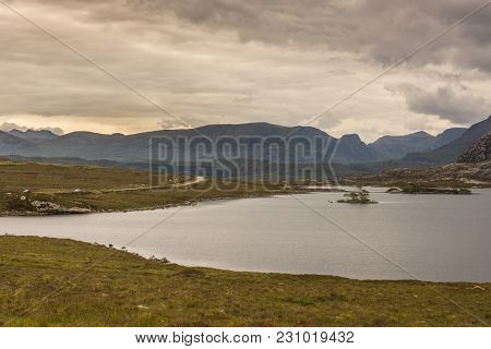 Loch Tollaidh, Scotland - June 9, 2012: Heavy Dark Brown Cloudscape Over Lake Colors Water As Brown.