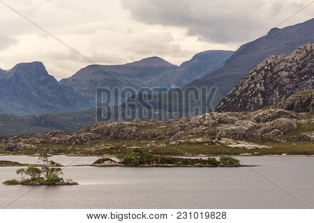 Loch Tollaidh, Scotland - June 9, 2012: Heavy Dark Brown Cloudscape Over Lake Colors Water As Brown.