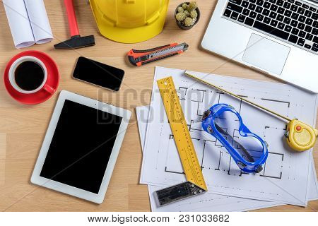 Architectural Office Desk With Laptop,smart Phone,tablet,cup Of Coffee And Engineer Equipment.top Vi
