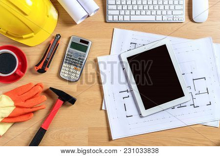 Architectural Office Desk With Laptop,smart Phone,tablet,cup Of Coffee And Engineer Equipment.top Vi