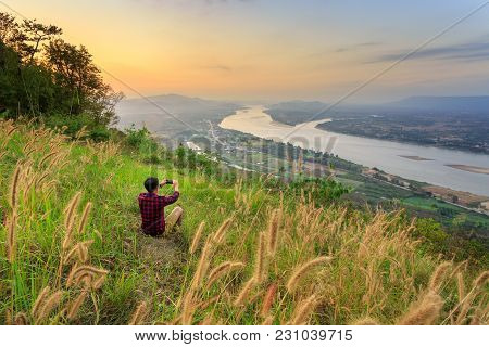 Travel Man Stand For Take Photo On Rock Stone Near Cliff At 