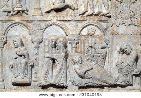 VERONA, ITALY - MAY 27: Annunciation, Visitation and Birth of Jesus, medieval relief on the facade of Basilica of San Zeno in Verona, Italy, on May 27, 2017.