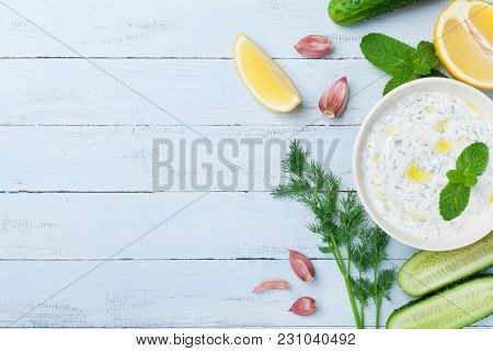 Greek Dip Sauce Or Dressing Tzatziki From Sour Cream Yogurt Decorated With Olive Oil And Mint On Woo