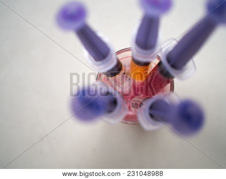 Closeup Top View  Liquid Medicine In Syringe In Glass