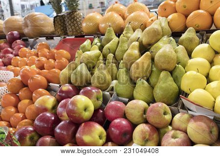 Bright Background Of Fresh Fruits. Oranges, Apples, Pears, Pineapple, Pomegranate, Pumpkin, Persimmo