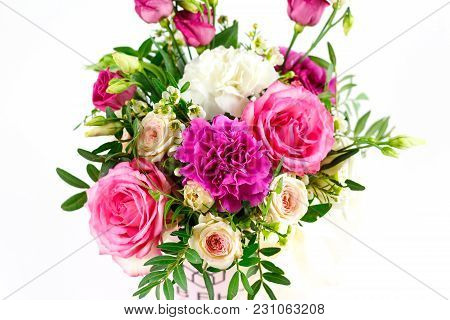 Composition Of Flowers In A Pink Hatbox. Tied With Wide White Ribbon And Bow.