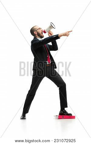 Side View Of Man Screaming On Megaphone Over White Background. Young Casual Man Shouting. Shout. Cry