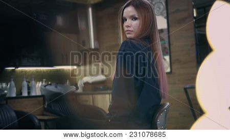 Beautiful Woman With Long Healthy Hair Is Looking In Camera, Turning Around, Playing With Her Colour