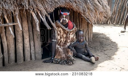Omo Valley, Ethiopia, September 2017: Portrait Of Unidentified Karo Tribe Woman With Her Child In Co