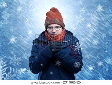 Gorgeous boy wearing warm clothing and freezing in cool snowy  concept