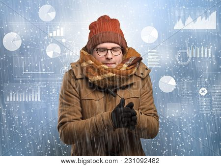 Young businessman shivering with graphs, reports and chart concept