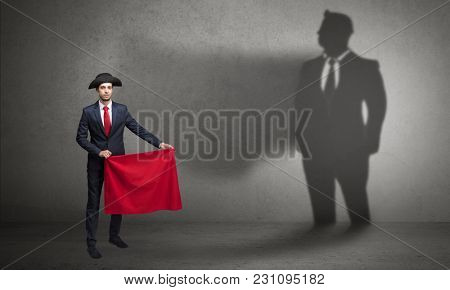 Businessman standing with red cloth on his hand and his shadow on the background