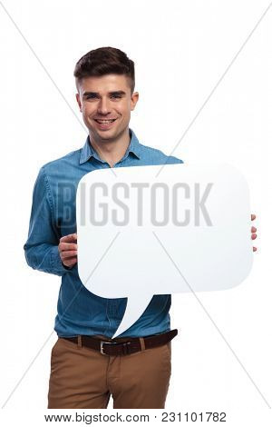 young casual man hlding a blank speech bubble on white background