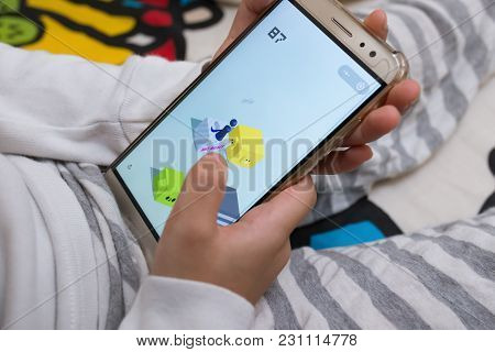 Zhongshan,china-march 2,2018:kid Sitting On Bed & Playing A Game Named Little Jump Inside Wechat Own