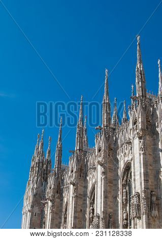 Some Spiers Surmounted By Statues Of The Milan Cathedral With A Clear And Blue Sky
