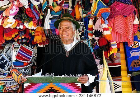 Banos, Ecuador - 04 August 2012: The Equadorian In A Traditional National Costume Is Selling Handicr