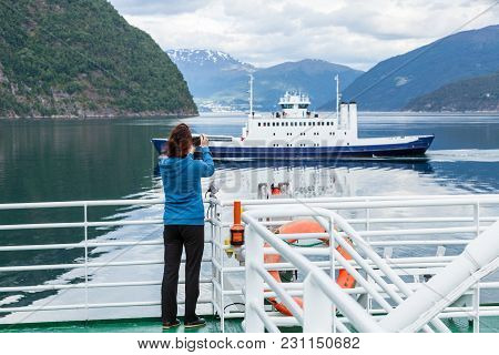 Tourism Vacation And Travel. Tourist Woman On Cruise Ship Enjoying Fjord View, Taking Photo With Cam