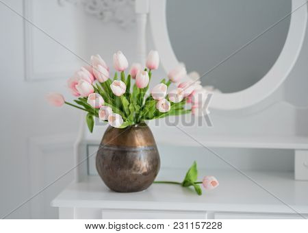 Artificial Tulips On A Table With A Mirror.
