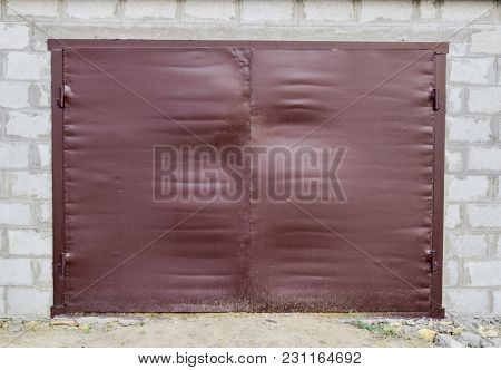 Iron Gates On The Garage. Brown Gates Made Of Steel.