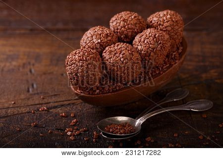 Chocolate Egg With Filling For Easter On Wooden Background
