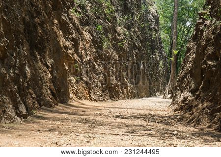 Old Gravel Path Through The Hellfire Pass Memorial In Kanchanaburi, Thailand., Rocky Mountain Road.