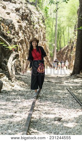 Asian Female Travel At Old Gravel Path Through The Hellfire Pass Memorial In Kanchanaburi, Thailand.