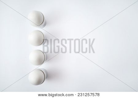 White Eggs Standing On Egg Cup Isolated On White Background, Copy Space. Row Of Boiled Eggs In Stand
