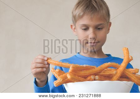 Child Eating Popular Sweat Spanish Dessert Churros.