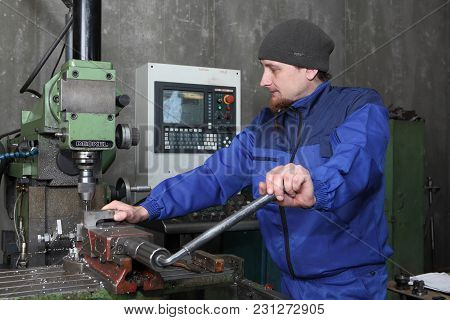 St. Petersburg, Russia - May 30, 2017: Factory Worker Set Up Metal Working Part Into Cnc Punching, M