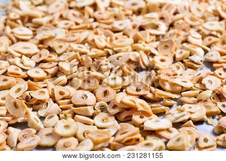 A Very Close View Of A Layer Of Flaked Garlic, Close Up