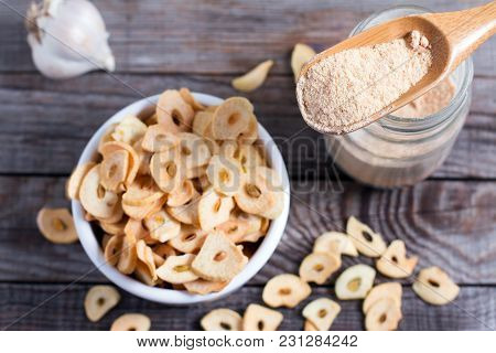 Spoon With Granulated Dried Garlic On Old Wooden Background