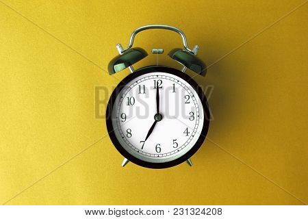 Vintage Black Alarm Clock On Yellow Color Background