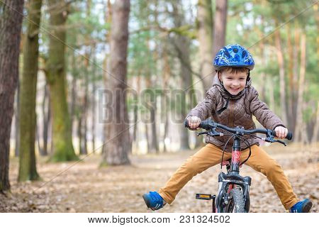 Happy Kid Boy Of 3 Or 5 Years Having Fun In Autumn Forest With A Bicycle On Beautiful Fall Day. Acti