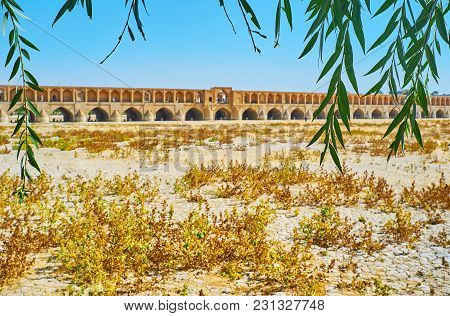 The Medieval Si-o-se-pol Bridge Through The Green Willow Branches, Koudak Park, Isfahan, Iran.
