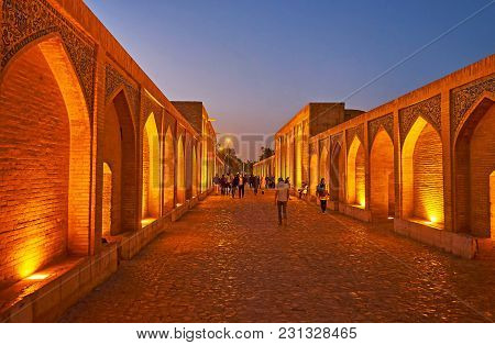 Isfahan, Iran - October 20, 2017: The Evening Walk Along The  Khaju Bridge With The View On Brick Ni
