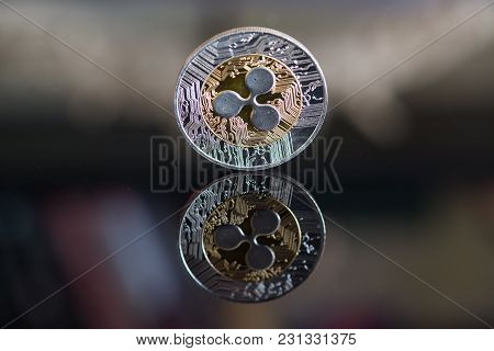 Ripple Cryptocurrency Coin On Black Mirror Background