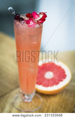 Pink, Bright Cocktail With Grapefruit, Decorated With Flowers