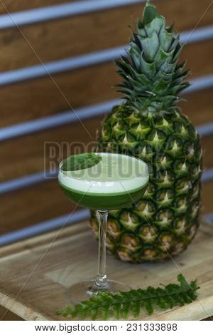 Bright Summer Green Cocktail With Pineapple On The Wooden Table