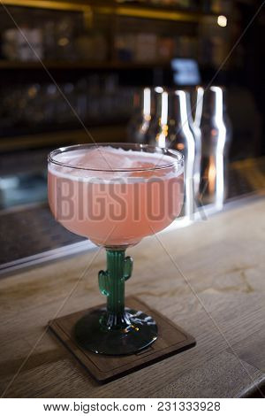 Pink Cocktail In Funny Glass On The Rack