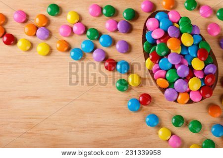 Chocolate Egg With Filling For Easter On Wooden Background