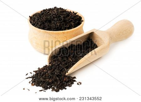 Black Tea Leaves In Wooden Plate And Spoon On A White Background, Isolated.