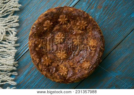 Round Loaf Karavai On Wooden Rustic Table Background. Traditional Slavic Russian And Ukranian Festiv