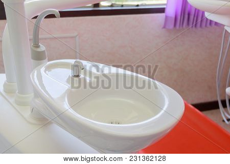 Sink Medical Equipment Dentist Close Up, Ceramic Spittoon And Water Filler In Clinic
