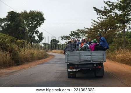 Oio, Republic Of Guinea-bissau - January 28, 2018: Group Of People Traveling In The Back Of A Truck 