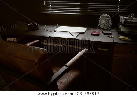Work Space On Black Table Of A Photographer Or Designer With Laptop , Retro Camera And Fan , Stylish