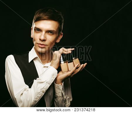 Young male make up artist posing with foundation for make-up